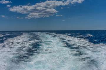 Fototapeta na wymiar Italy, Cinque Terre, Monterosso, a man riding a wave in the ocean