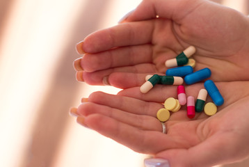 Pills. Hand. Woman take pills. Capsule. Vitamins on white background. Vitamins. Colorfull. Life care. Medication on the lab. Drugs. Tablets on hands. Painkiller. Pain. Headache. Ballyache. Handache.