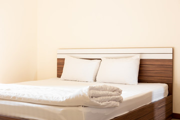 Fototapeta na wymiar Comfortable white bed in the room