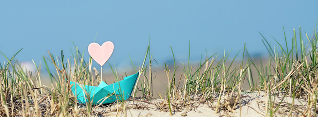 Papierboot am Strand in den Dünen