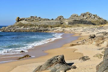Fototapeta na wymiar Beach and prehistoric settlement ruins. Castro de Baroña, Coruña, Spain.
