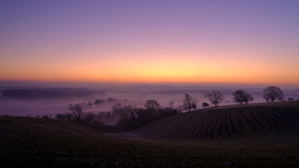 Misty morning sunrise over the Hambledon valley, Hampshire, UK