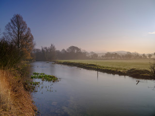 Misty morning light on the River Meon near Exton, South Downs National Park, Hampshire, UK