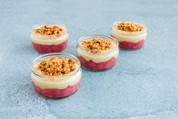 Pink Rhubarb and Custard Dessert with Crumbs in Ramekins