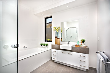 Washroom with a bath tub beside a window and tap