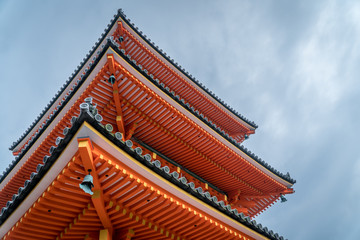 Fototapeta na wymiar Traditional Orange Pagoda Buddhist Temple Roof, in Naga, Japan. Blue Sky in Background.