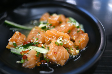 Salmon salad on black plate