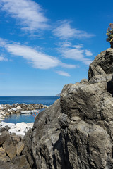 Fototapeta na wymiar Italy,Cinque Terre,Riomaggiore, a rocky island in the middle of a large rock