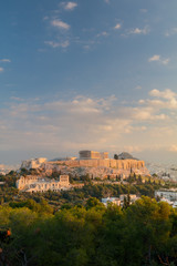 Obraz premium Vertical view on the Acropolis in Athens at sunrise. Scenic travel background with dramatic clouds. Greece