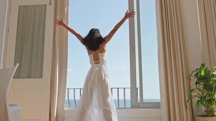 travel woman dancing in hotel room having fun celebrating summer vacation enjoying carefree holiday lifestyle