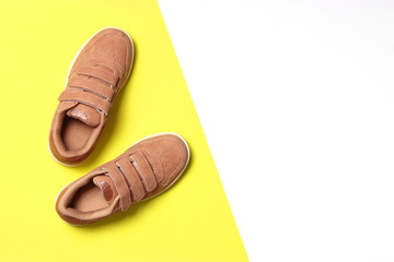 Children's shoes on a colored background top view. Children's footwear.