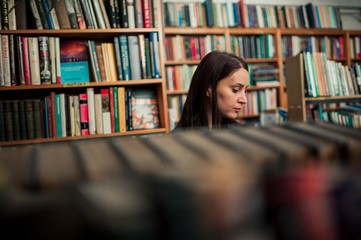 woman surrounded with books in library