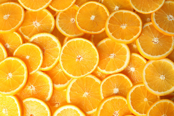 Many sliced fresh ripe oranges as background, top view