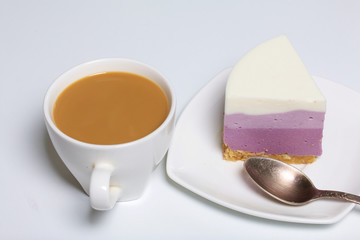 Blueberry cheesecake. A piece of ready-made dessert on a saucer. Jelly layers of different colors are visible.