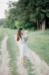 the mother plays with her daughter in her arms