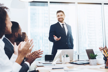 Business team applauding to boss at meeting