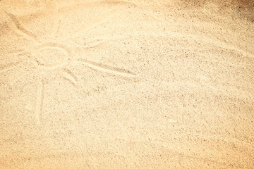 Fototapeta na wymiar Beautiful drawing on the sand of the sea background