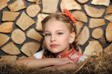 girl blonde dressed in country style on a hayloft