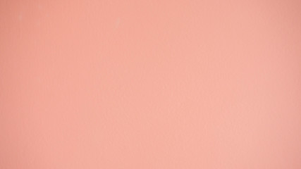 Empty interior light pink room wall surface abstract texture pattern background. Copy space for ad text usage. Blank and pastel colored wall is available for background, wallpaper and banner designs.
