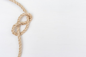 Ship ropes on white wooden background. Double stopper. Copy space.