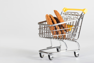 Homemade cookies in a cart, a close-up at the white background.