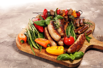 Assorted delicious grilled meat with vegetable on a barbecue. Grilled pork shish or kebab on skewers with vegetables . Food background shashlik