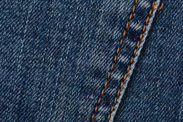 Blue jeans texture closeup. Denim with seam background.