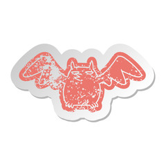 distressed old sticker of a night bat