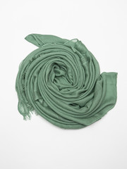 Green scarf on white background. Top view.