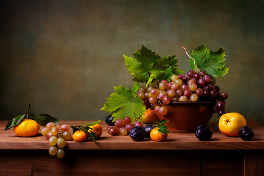 Still life with grapes, pears and plums