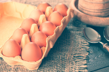 raw eggs in a box on the table. background with chicken eggs in the egg tray.