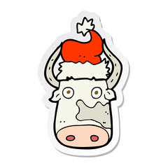 sticker of a cartoon cow wearing christmas hat