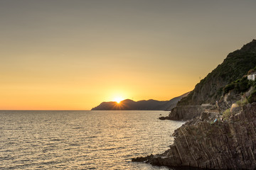 Golden sunset at the cliff at the Italian Riviera in the Village of Riomaggiore, Cinque Terre, Italy