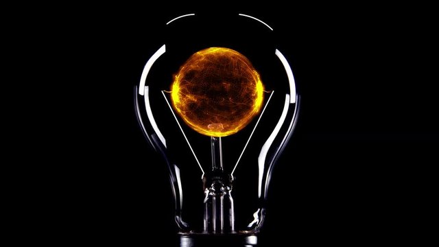 Light bulb filled with orange plasma against a black background close-up view