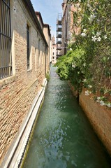Fototapeta na wymiar Narrow long canal of Venice, Italy