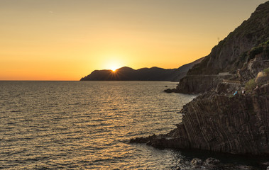 Golden sunset at the cliff at the Italian Riviera in the Village of Riomaggiore, Cinque Terre, Italy