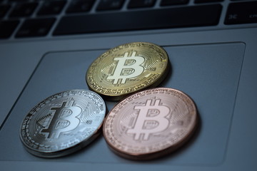 Gold currency bitcoin currency on keyboard laptop computer, electronic finance concept. Bitcoin coins. Bussiness, commercial, exchange.