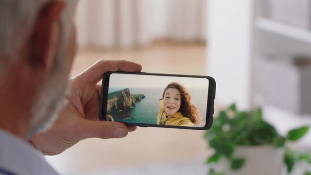 mature man having video chat using smartphone waving at daughter on vacation in scotland enjoying connection grandfather chatting on mobile phone