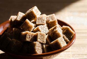 Brown sugar cubes in a bowl on the table