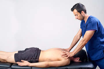 Obraz premium Physiotherapist doing a mobilization neck of female patient. Manual therapy. Neurological physical examination. Osteopathy, Chiropractic