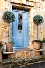 Fototapeta na wymiar entrance of a stone house with a blue door