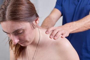 Physiotherapist doing a mobilization neck of female patient. Manual therapy.  Neurological physical examination. Osteopathy, Chiropractic