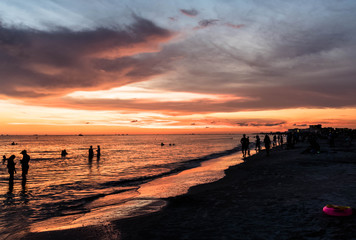 People partying on the beach at sunset in Treasure Island, Florida