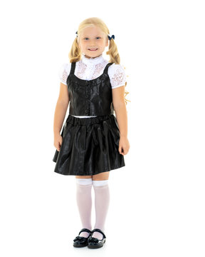 Beautiful little girl in a school uniform.