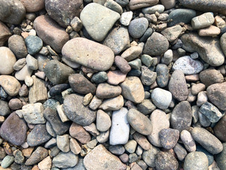 Sea stones background, little rocks, small, stones, in many shades of grey, white and blue, texture of little rocks
