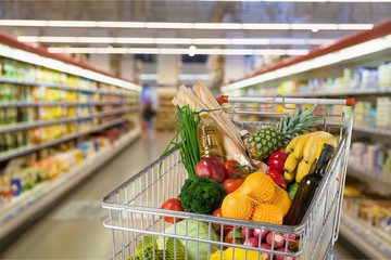 Shopping cart full with various groceries © BillionPhotos.com