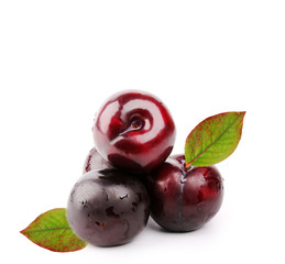 plums with leaves isolated on white background