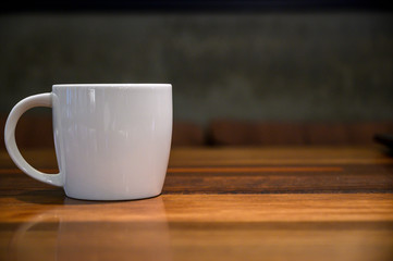 coffee cup on the wood table close up