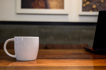 coffee cup on the wood table close up