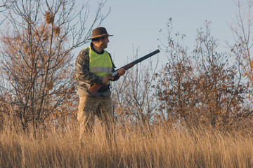 Hunters with a german drathaar and spaniel, pigeon hunting with dogs in reflective vests